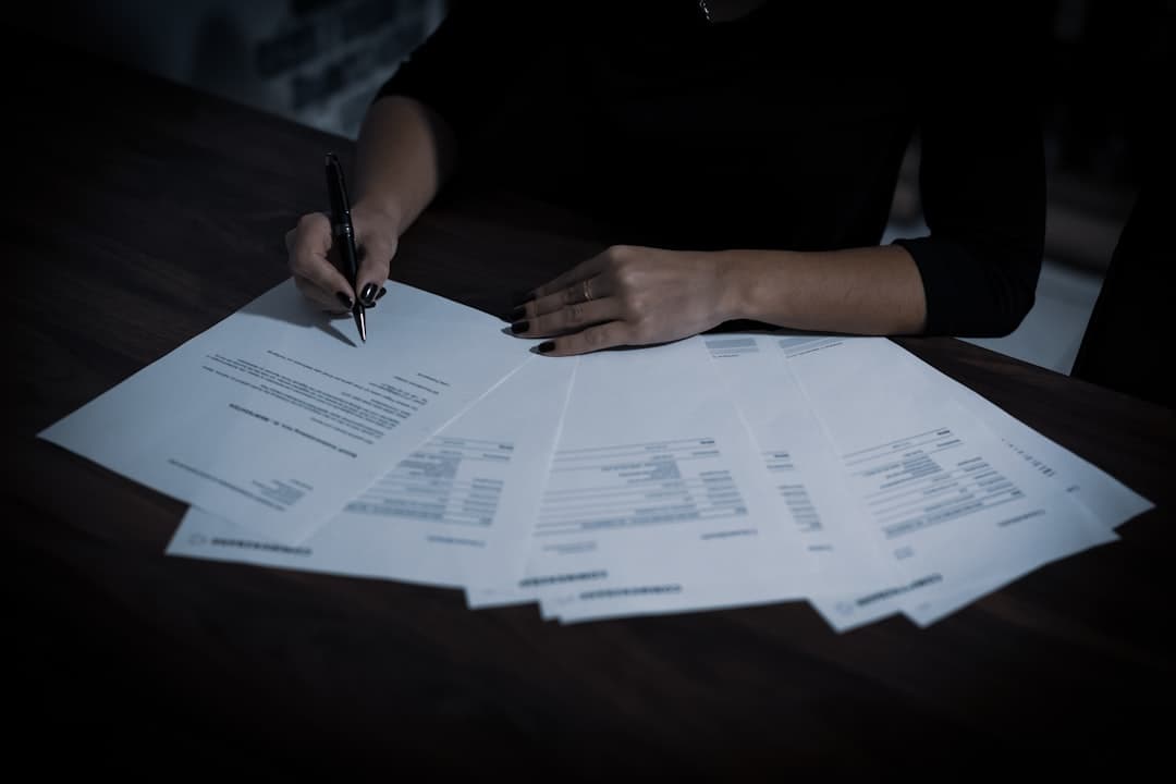 Person reading legal documents carefully at a desk