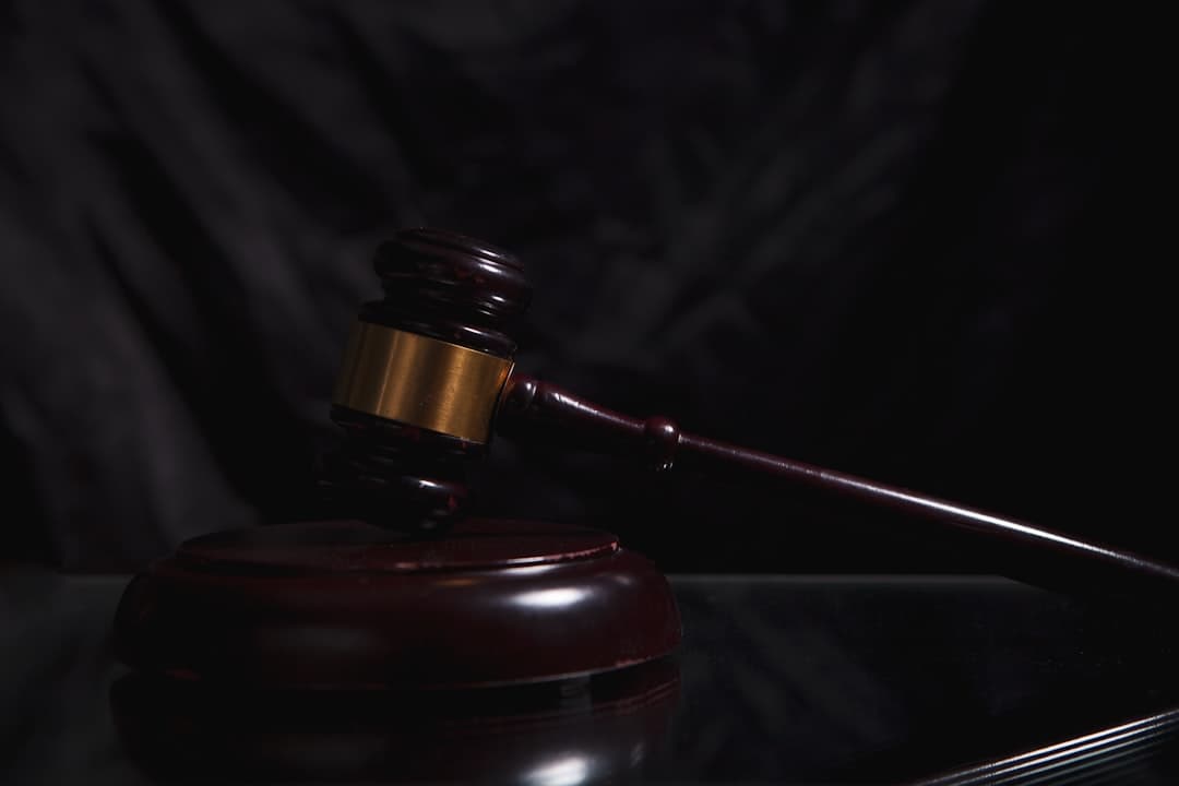 A courtroom gavel sitting on legal documents