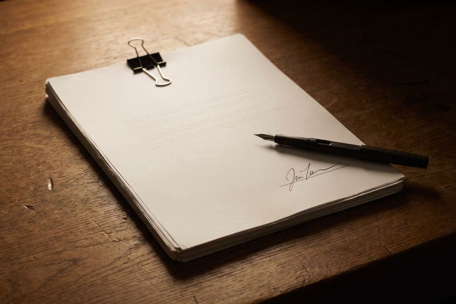 A signed, bound audit report on a desk.
