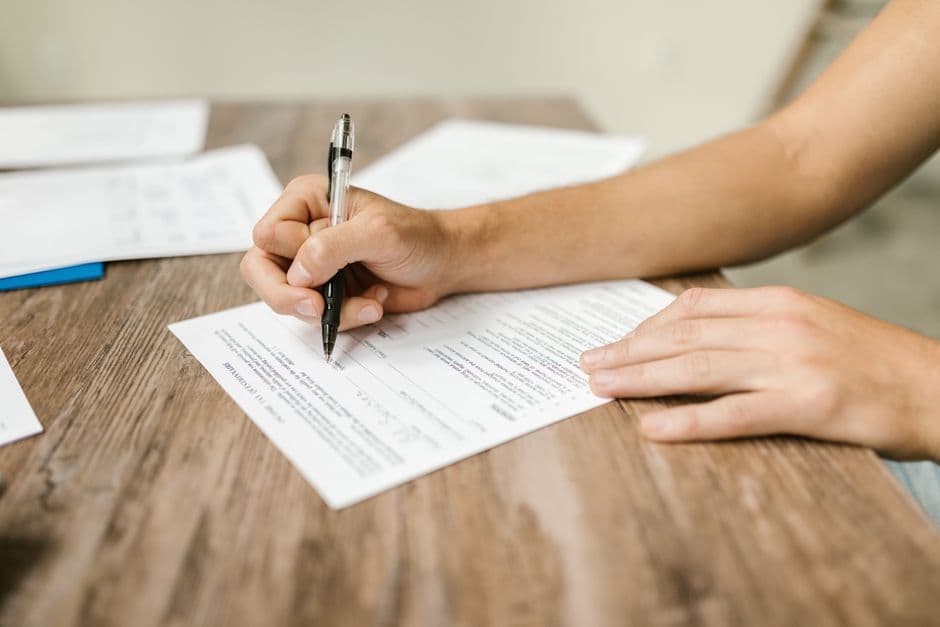 hand filling out a legal document